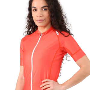 Close-up side view, from the waist up, of a woman wearing a red poppy cycling jersey.