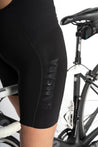 Close-up side view of Samsara wordmark on the side of black cycling shorts.