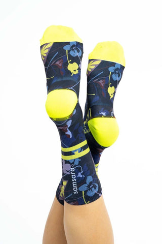 Bottom view of women’s cycling socks with Winter Floral print, yellow ankle stripes, toes, heals and Samsara wordmark on back.